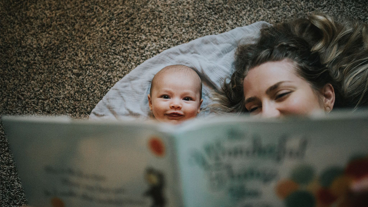 mother reads to a baby
